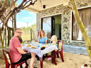 a group of people sitting at a table at Coco and Corks Villa in Negombo