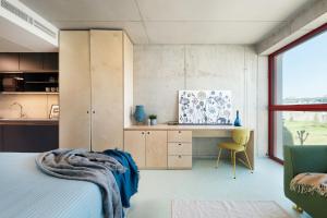 a bedroom with a bed and a desk with a chair at Domeq FREE Parking, Gym, Co-working and Terrace in Komárov +43 photos