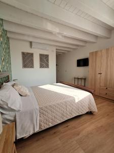 a bedroom with a large bed and a tv at b&b Civico 30 in Lonato