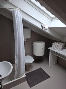 a bathroom with a toilet and a sink at Villa Doris Mlini in Mlini