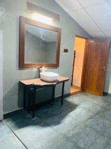 a bathroom with a sink and a mirror on the wall at Villu Trails Wilpattu in Wilpattu