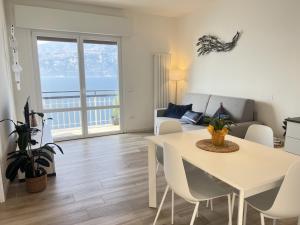 a living room with a table and a couch at Sottovento Beths House in Brenzone sul Garda