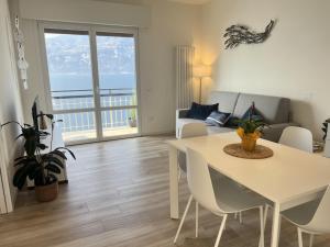a living room with a table and a couch at Sottovento Beths House in Brenzone sul Garda +18 photos