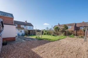 a backyard of a house with a fence at 38 Prospect Place, Leiston in Leiston