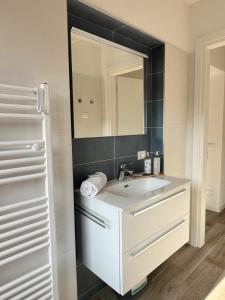 a bathroom with a sink and a mirror at Sottovento Beths House in Brenzone sul Garda