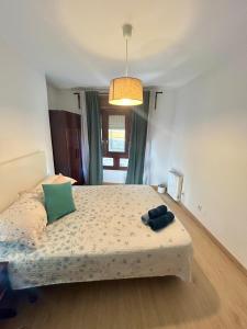 a bedroom with a large bed with a light at Del Valle 1 in Cudillero