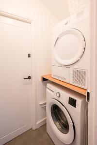 a washing machine with a microwave on top of it at 38 Prospect Place, Leiston in Leiston