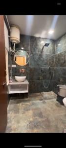 a bathroom with a sink and a toilet and a mirror at Shail Shikhar Heritage Inn in Joshīmath +14 photos