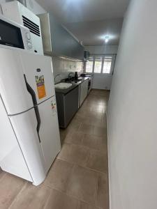 a kitchen with a white refrigerator and a stove at Casa Kempes in Córdoba +1 photo