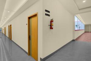 a hallway of an office building with a fire hydrant on the wall at Hotel O Ciapus Bogor in Bogor +21 photos