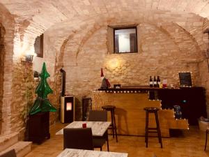 a bar with a christmas tree in a stone wall at Palazzo Bruschi in Pergola