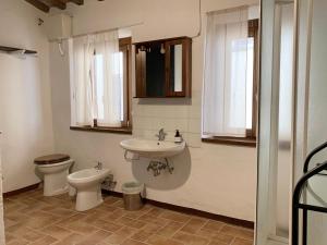 a bathroom with a toilet and a sink at Palazzo Bruschi in Pergola +11 photos