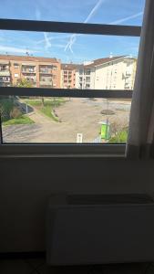 a view of a parking lot from a window at Savi Residence in Savigliano