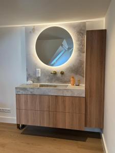 a bathroom with a sink and a mirror at Homes by the C in Zandvoort +110 photos