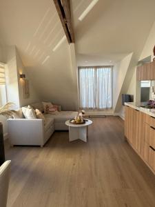 a living room with a couch and a table at Homes by the C in Zandvoort