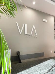 a sign for a wha hotel on a wall at Vila Hotel By VimaHotels in Guimarães +29 photos