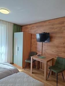 a bedroom with a desk and two chairs and a bed at Private Rooms Valis in Varna City