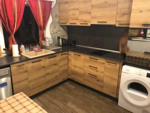 a kitchen with a sink and a washing machine at Paradise - Guest House in Beden