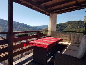 a table and couch on a balcony with a view at Paradise - Guest House in Beden