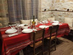 a red table with chairs and a red table cloth at Paradise - Guest House in Beden