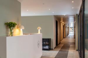 a hallway in a building with a reception desk at Bob W Rome Testaccio in Rome