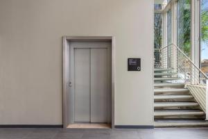 a door to a building with stairs next to it at Bob W Rome Testaccio in Rome +18 photos