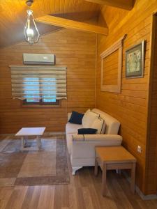 a living room with a couch and a table at ŞAH apart in Kemer +101 photos