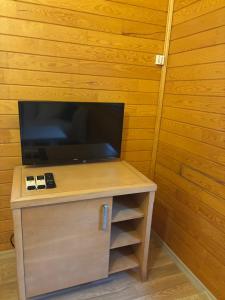 a small desk with a television on top of it at ŞAH apart in Kemer