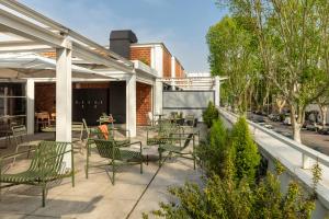 a patio with chairs and tables on a building at Bob W Rome Testaccio in Rome