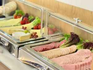 a buffet with different types of food on display at Alpha & Omega Hotel Stuttgart - air-conditioned in Stuttgart