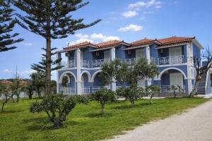 a blue house with trees in front of it at Stelios Studios - Zante Seaview Nests in Tragaki