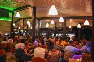 a large crowd of people sitting in a restaurant at VILA DVG II in Costinesti