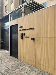 a building with two garage doors with the words no warehouse at Aconchego in Maringá