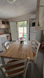 a large wooden table in a kitchen with chairs at Villa Dependance in Taranto +8 photos