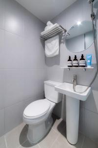 a white bathroom with a toilet and a sink at 4rest Stay Jongno in Seoul