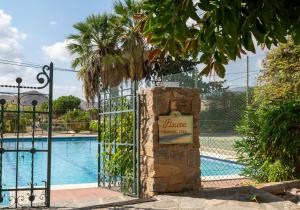 a gate with a sign in front of a swimming pool at Finca Antas Villa in Antas