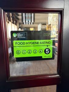 a food hygiene rating sign on a glass door at Crockets Hotel in Newcastle upon Tyne