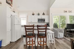 a kitchen with a table and two chairs at The Bluebird - 34 Meadow View in Cherry Valley