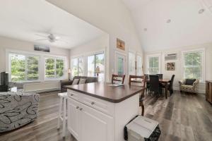 a kitchen and living room with a table and chairs at The Bluebird - 34 Meadow View in Cherry Valley