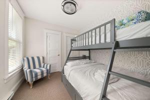 a bedroom with a bunk bed and a chair at The Bluebird - 34 Meadow View in Cherry Valley +87 photos