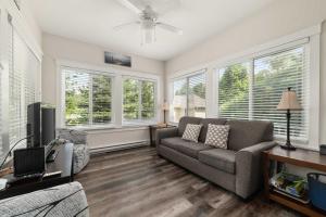 a living room with a couch and a tv at The Bluebird - 34 Meadow View in Cherry Valley