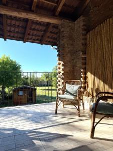 a patio with two chairs sitting on a porch at Monferrato Guest House - Il Murôn in Carentino