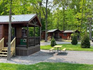 a cabin with a table and a bench in a park at HTR Niagara in Grand Island