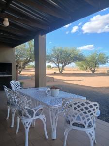 a white table and chairs on a patio at Vastrap Guest Farm in Grünau