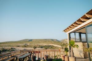 a house with chairs and a view of a hill at Residence Imsouane Surf Camp in Imsouane