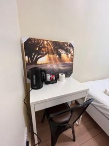 a white desk with a computer monitor on a bed at 13 Frankfield Terrace, Summerhill South, Cork, T12 PY79 in Cork