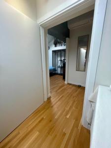 an open hallway with a hard wood floor in a apartment at Appartamento - Mini Suite in Brescia +8 photos