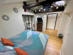 a bedroom with a bed with a colorful quilt on it at Appartamento - Mini Suite in Brescia