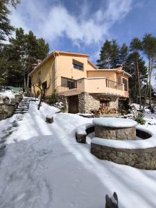 a house with a snow covered yard in front of it at EMAÚS in Castellar del Riu