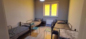 a room with three beds and a window at Jugata in Rudna Wielka